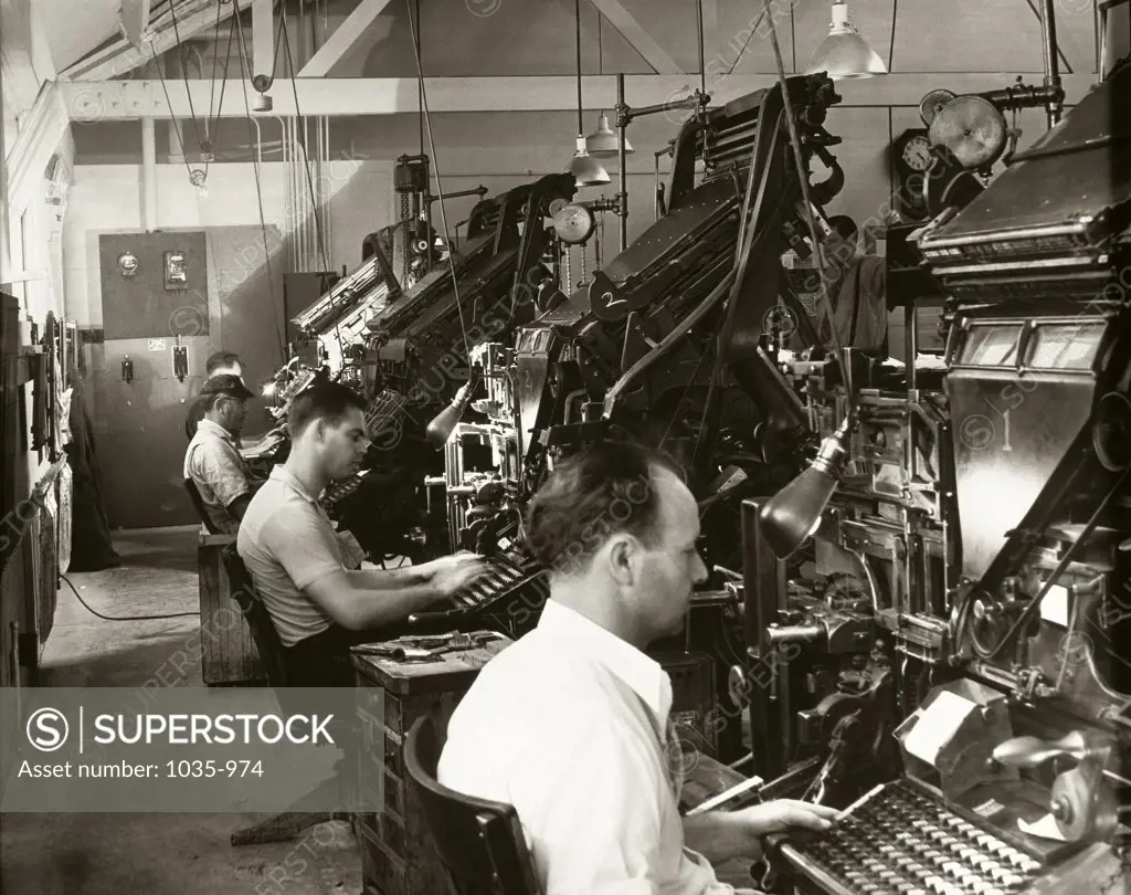 Side profile of technicians working on Linotype typesetting machines