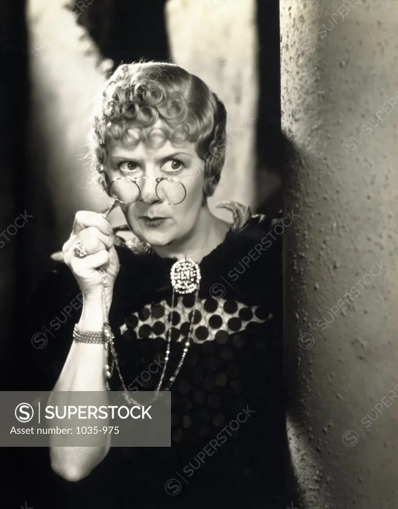 Close-up of a mature woman spying