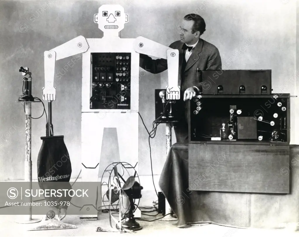 Mature man standing near a robot, Televox Robot, Westinghouse Electric and Manufacturing Company, 1926