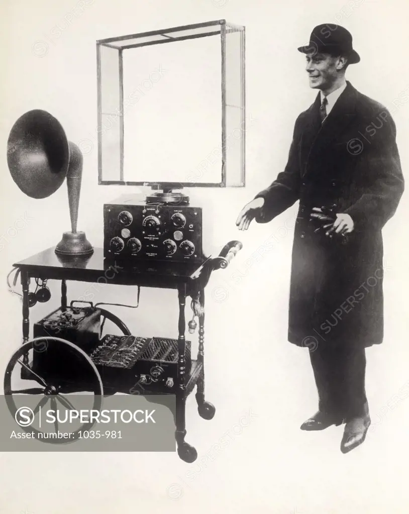 Mid adult man standing near a portable radio, Duke of York, 1923