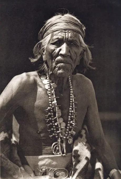 Close-up of a Native American man wearing traditional jewelry