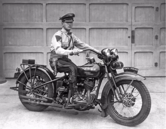 New Jersey:  1930. Trooper Haley of the New Jersey State Police poses on his Harley Davidson motorcycle.