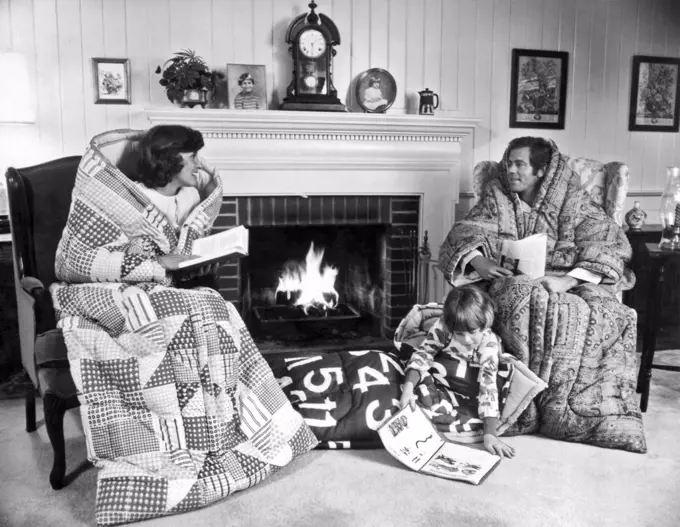 Detroit, Michigan:  October 15, 1977. A family cozies up for the upcoming winter during the 1970's energy crisis with Snug Sacks, which are like sleeping bags with sleeves.
