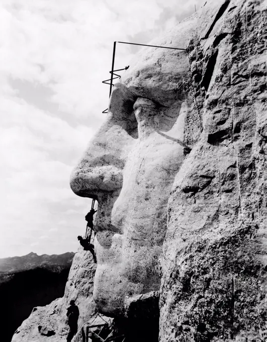 Mt. Rushmore, South Dakota: c. 1932. Workmen working on the face of George Washington on Mt. Rushmore.