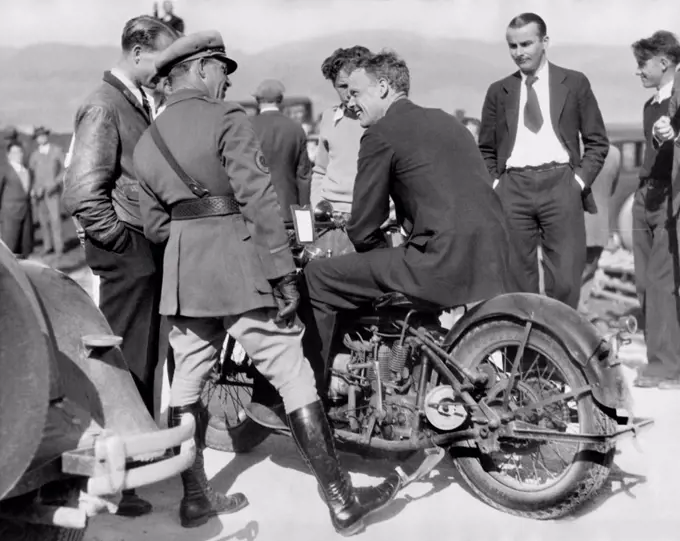 Monterey, California:  March 11, 1930 Charles Lindbergh tries out a motorcycle borrowed from State Traffic Patrolman Leo Ramsey during a trip to Del Monte.