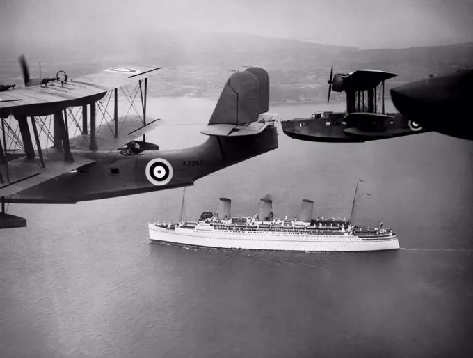England:   June 22, 1939 Royal Air Force flying boats escort the "Empress of Britain" as she steams up the Solent today.