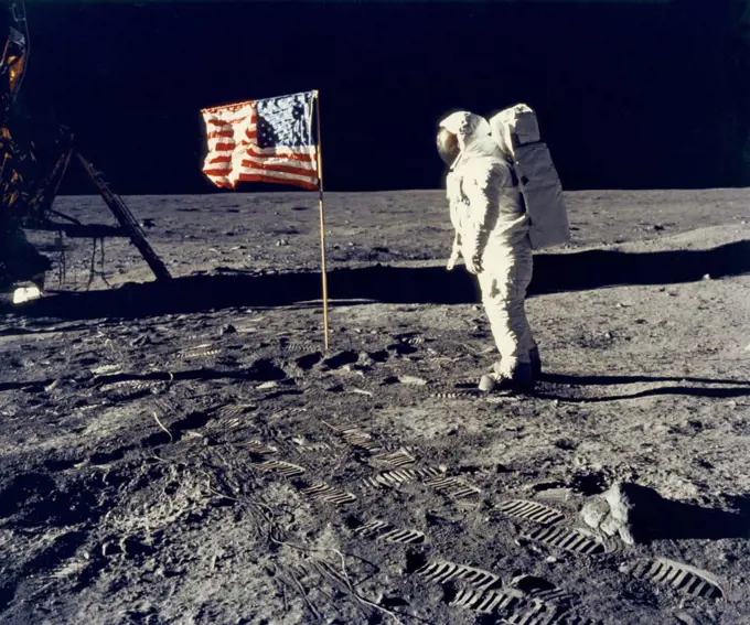 Moon:  July 20, 1969 Astronaut Edwin "Buzz" Aldrin, pilot of the lunar module, poses beside the United States flag during the Apollo 11 lunar landing. The Lunar Module "Eagle" is at the left. Commander Neil Armstrong took the photograph.