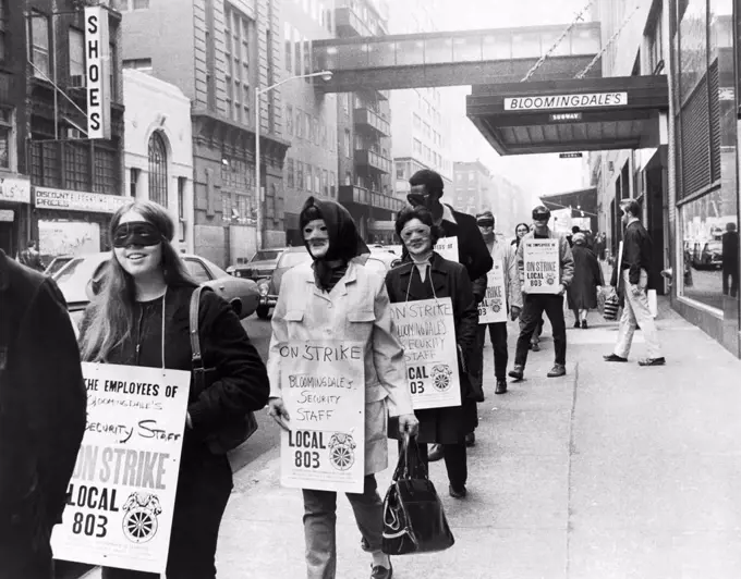 New York, New York:  October 23, 1971 Bloomingdale department store security guards and undercover detectives wear masks on the picket line so that they will not be recognized later on by potential shoplifters.