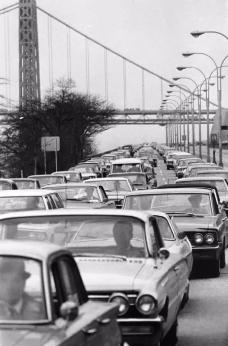 New York, New York:   May, 1966 Early morning rush hour traffic on the West Side Highway with the George Washington Bridge in the background.