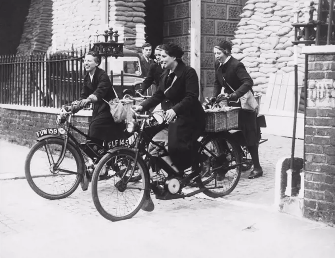 London, England:  September 25, 1939 Queen Charlotte's Hospital nurses have formed a motorcycle squad and here are some of them heading out on their rounds.