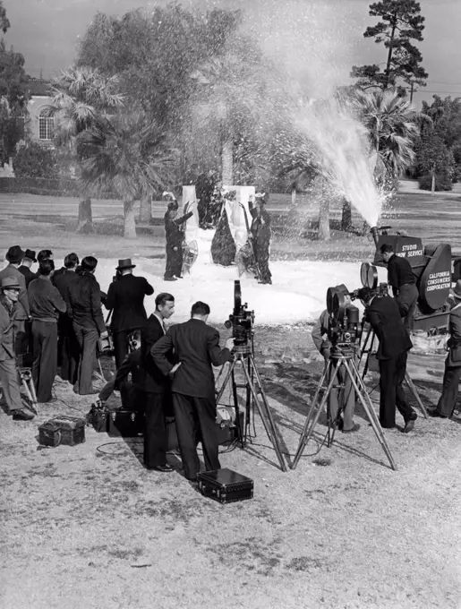 Los Angeles, California: c. January, 1938  Los Angeles Snow Sports Carnival Queen Frances Gilmore is crowned in Lafayette Park with the aid of a studio snow making machine.