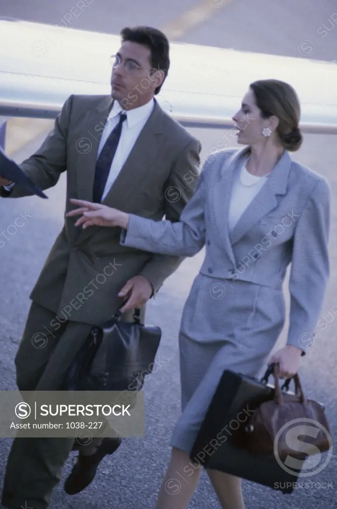Businessman and a businesswoman walking together
