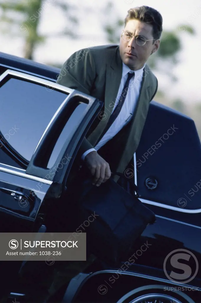 Businessman stepping out of a car
