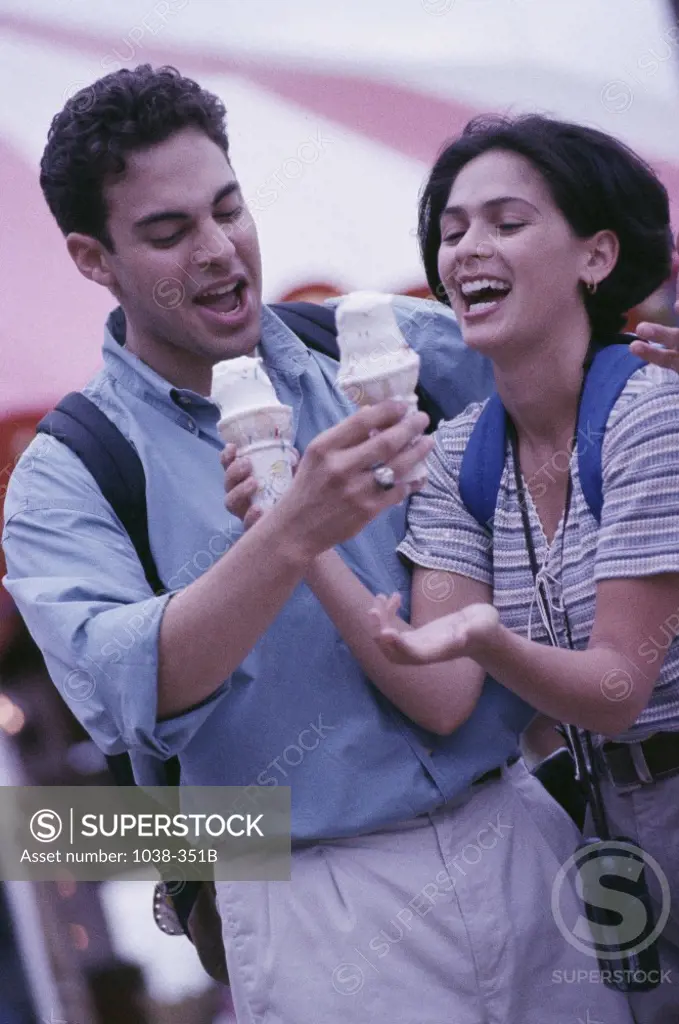 Young couple holding ice cream cones