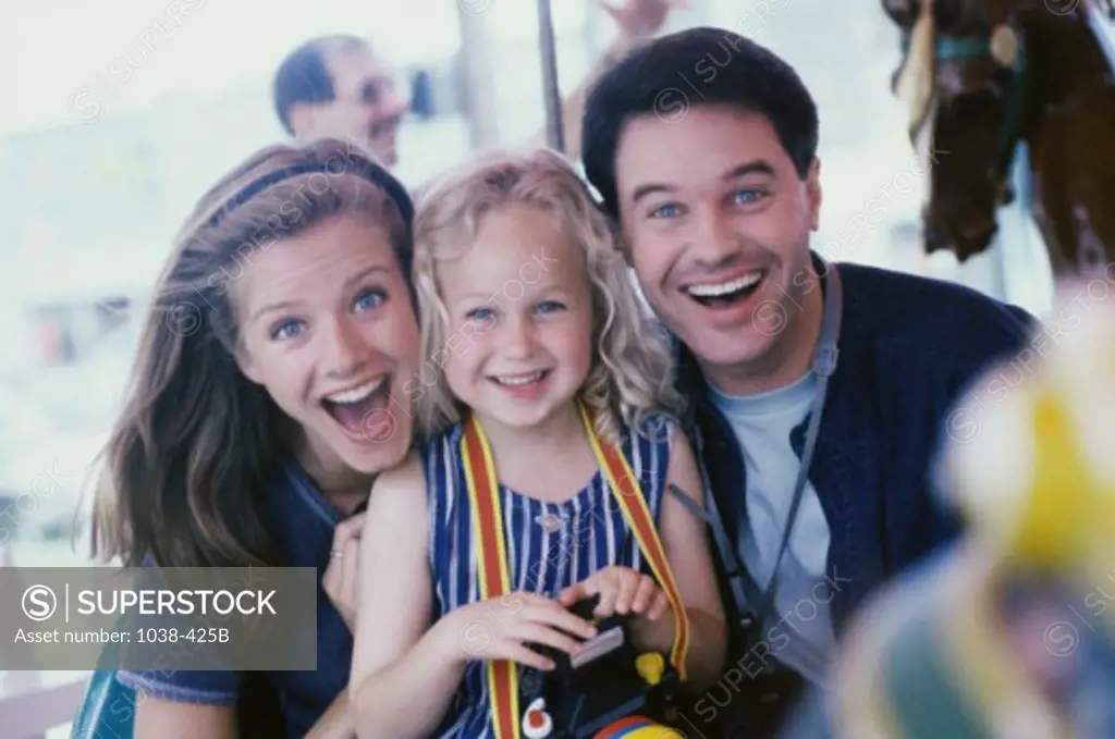 Portrait of parents smiling with their daughter