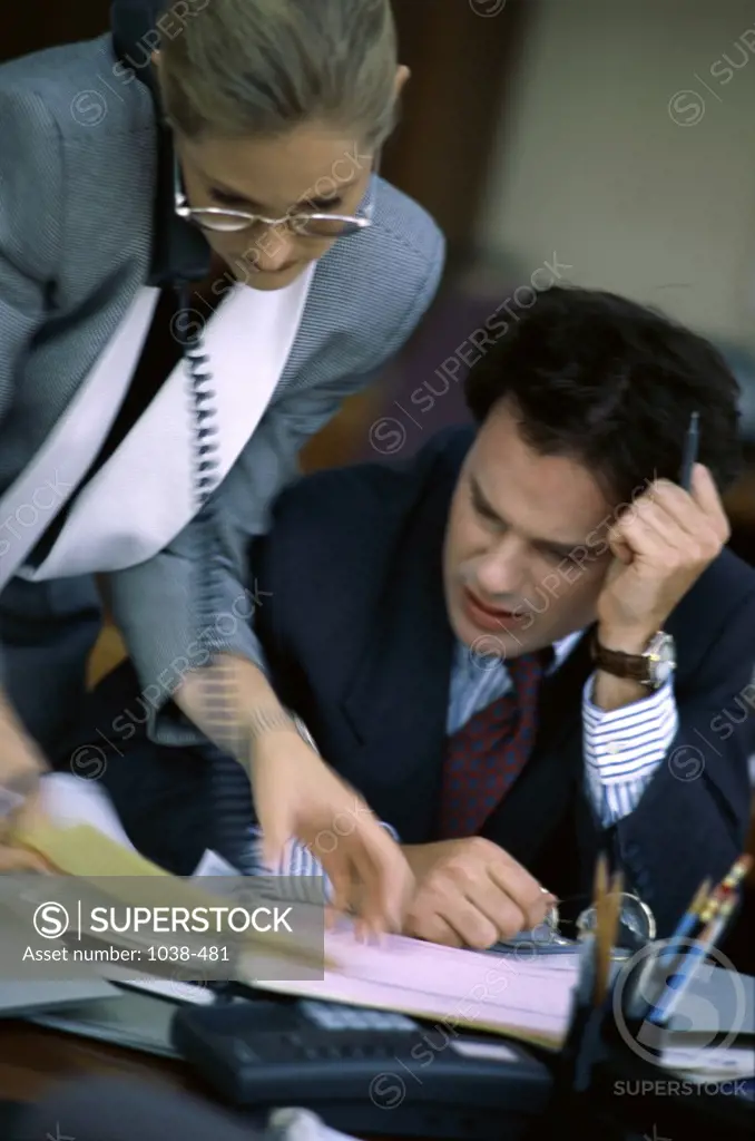 Businesswoman and a businessman in an office