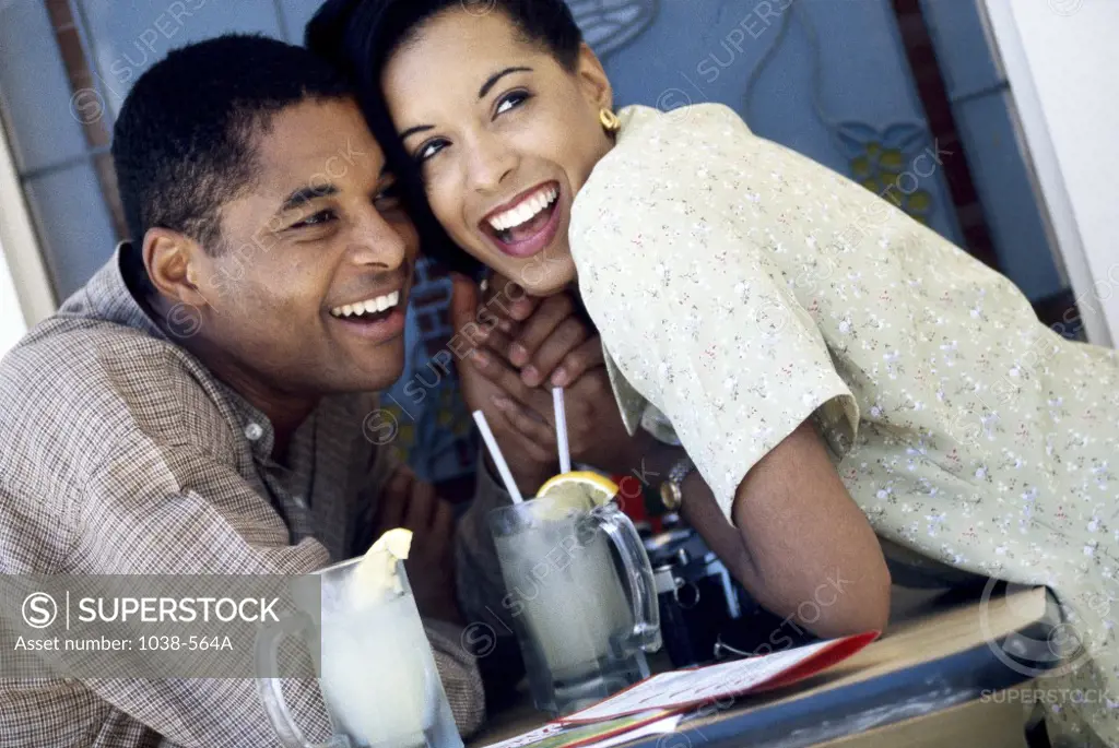 Young couple holding hands in a restaurant