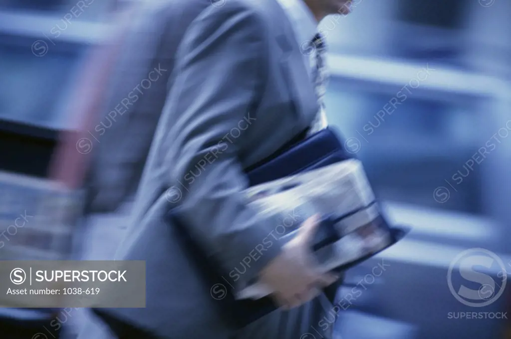 Mid section view of a businessman walking