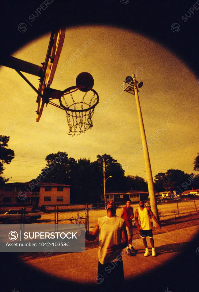 Basketball players practicing in a park