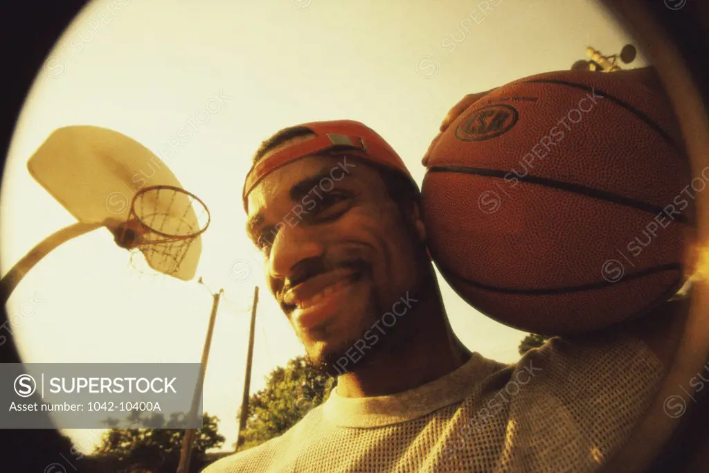 Close-up of a young man holding a basketball