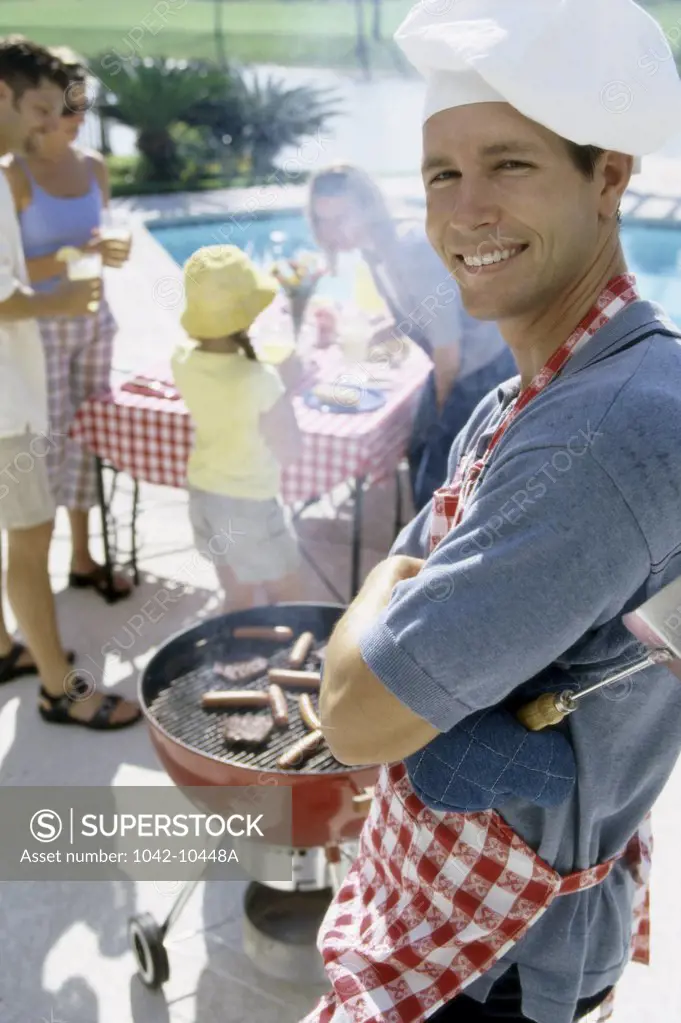 Portrait of a young man at a barbecue