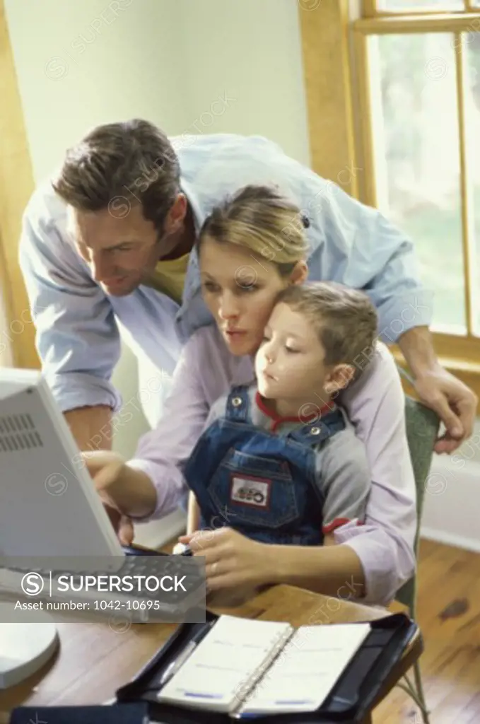 Parents and their son using a computer