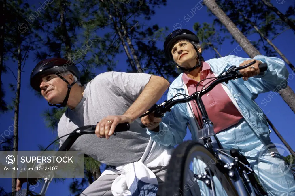 Low angle view of a mature couple cycling