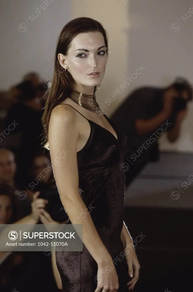 Female fashion model standing on a catwalk