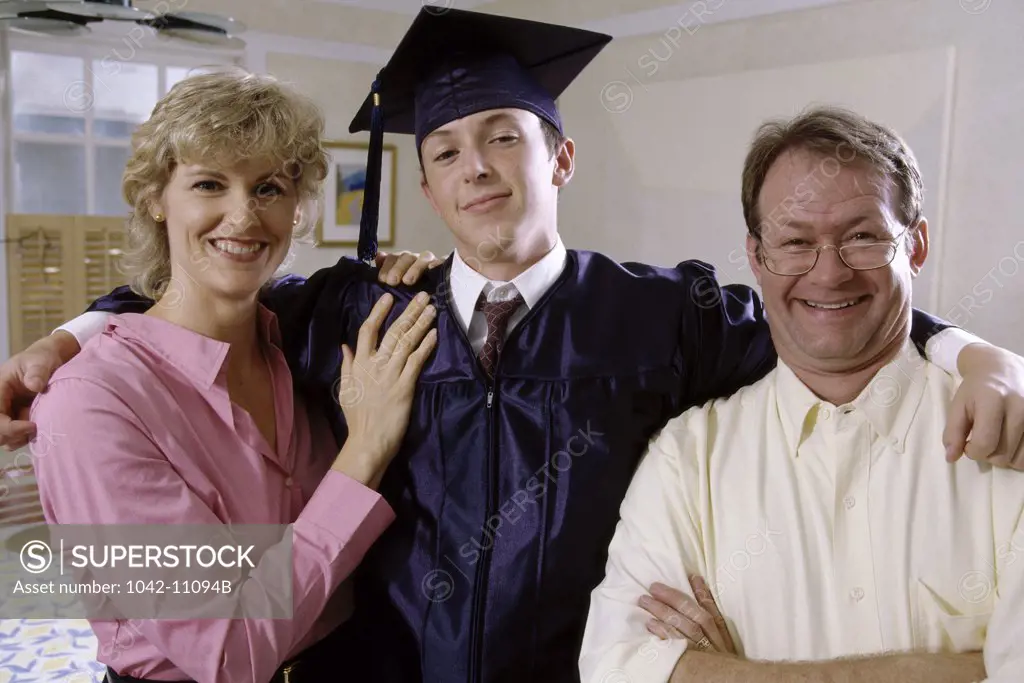 Portrait of a young male graduate with his parents
