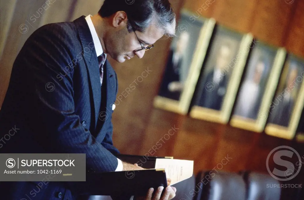 Side profile of a businessman reading a document