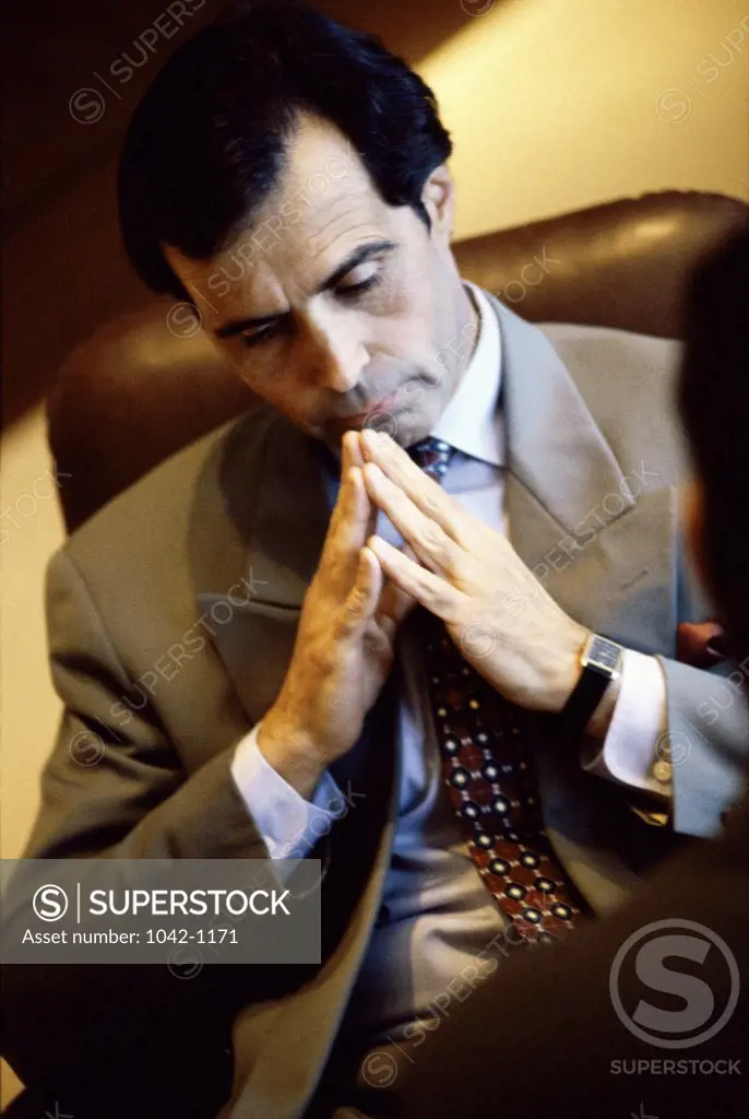 Businessman sitting in an office thinking