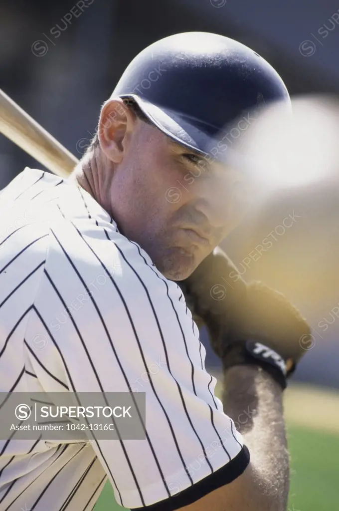 Close-up of a baseball player swinging a baseball bat