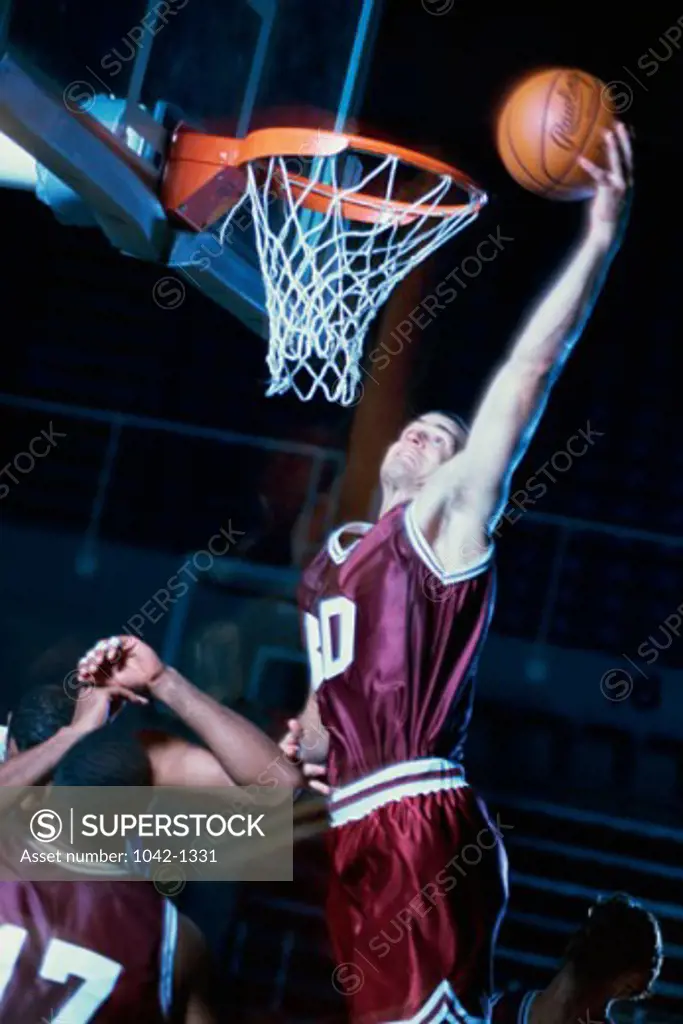Basketball player slam dunking