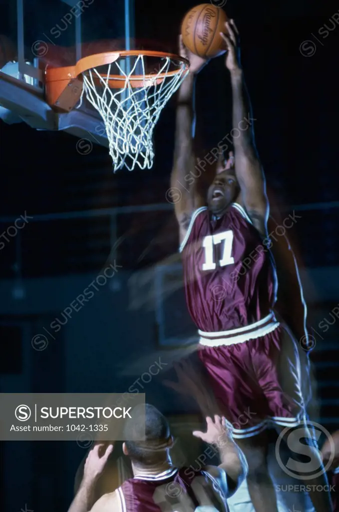 Basketball player slam dunking