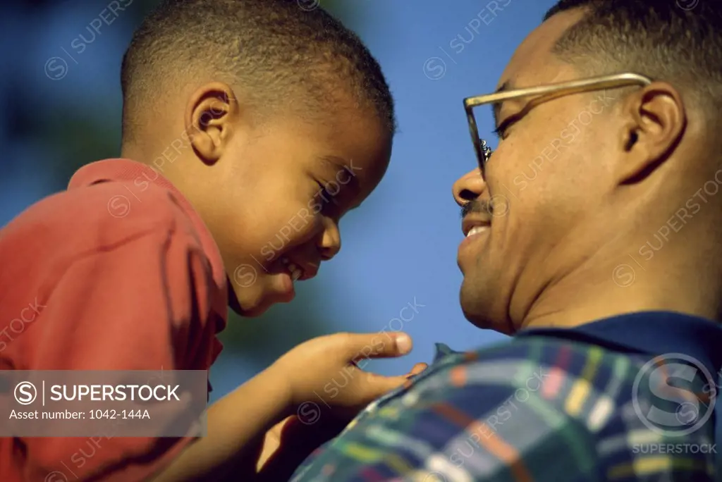 Side profile of a father holding his son
