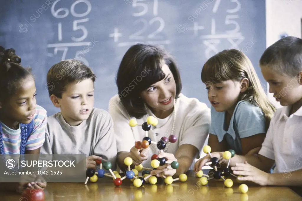 Teacher teaching her children about a molecular structure