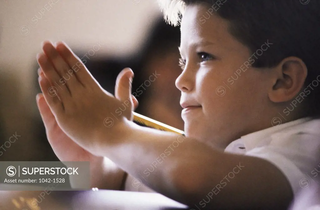 Close-up of a boy clapping