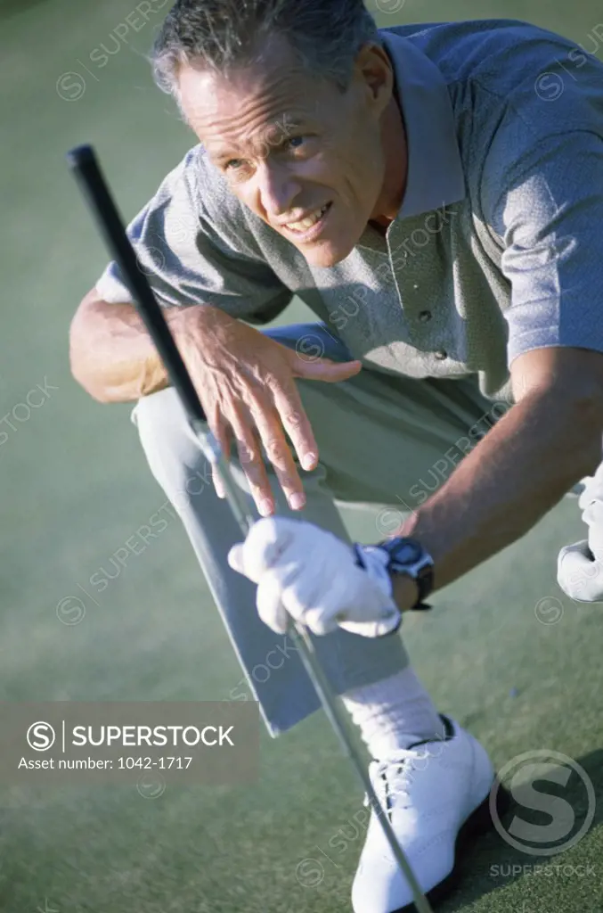 Senior man holding a golf club