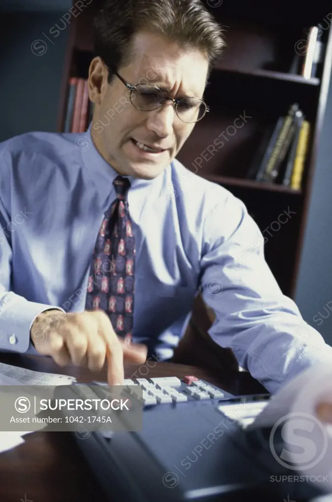 Businessman using an adding machine