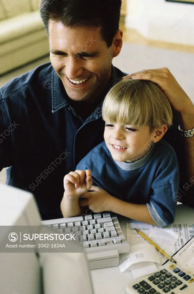 High angle view of a father and his son using a computer