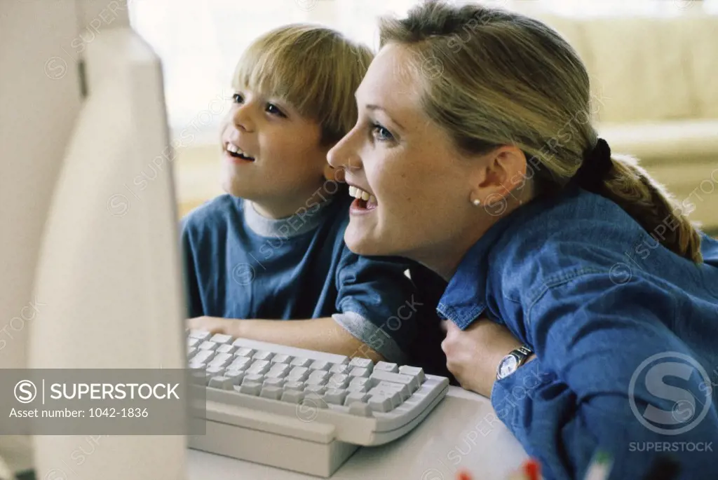 Side profile of a mother and her daughter using a computer