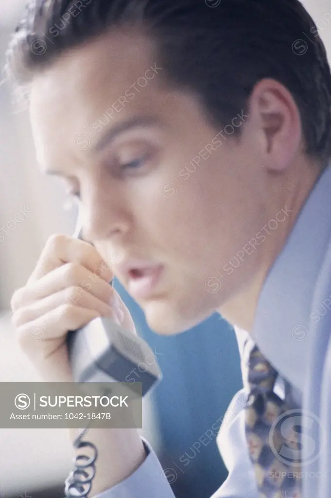 Side profile of a businessman talking on the telephone