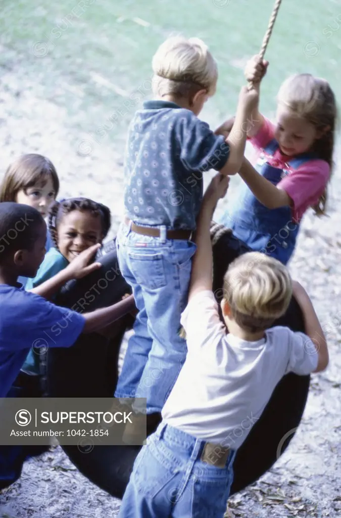 Group of children on a tire swing