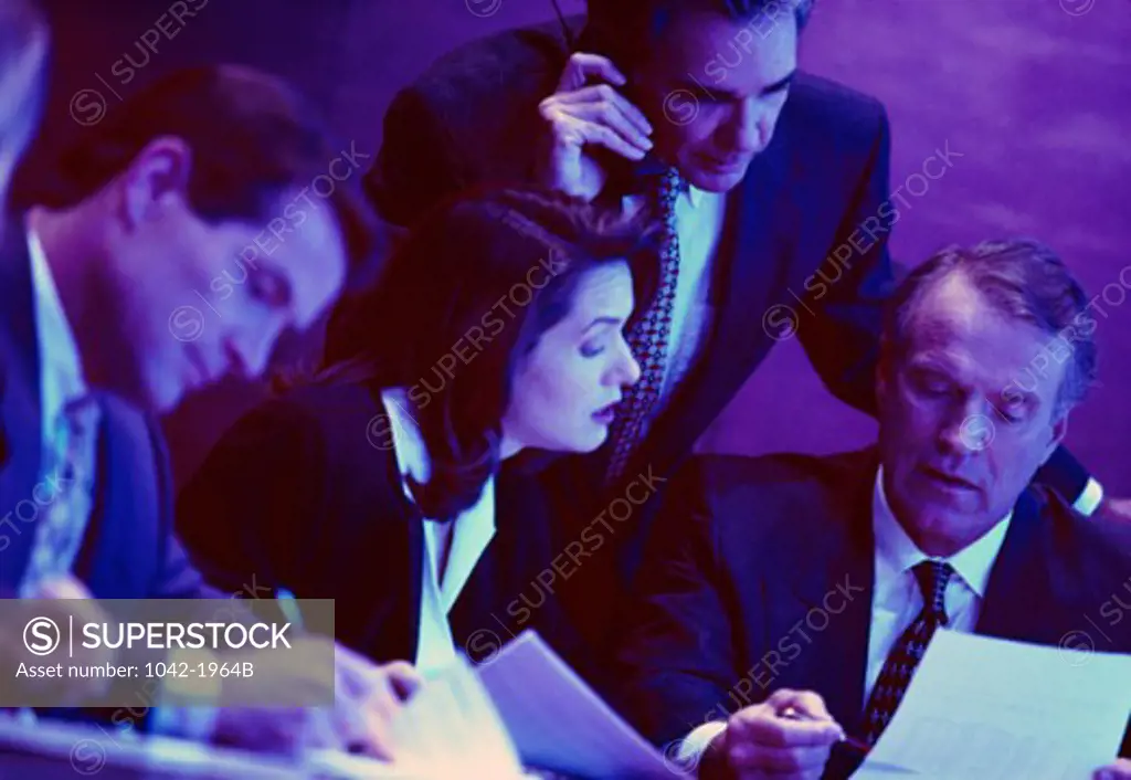 Businesswoman with three businessmen in a meeting