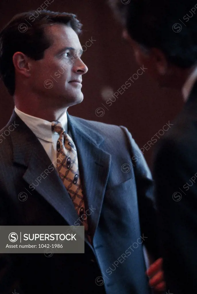 Close-up of two businessmen talking