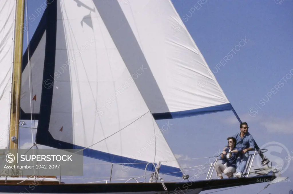 Young couple together on a sailboat