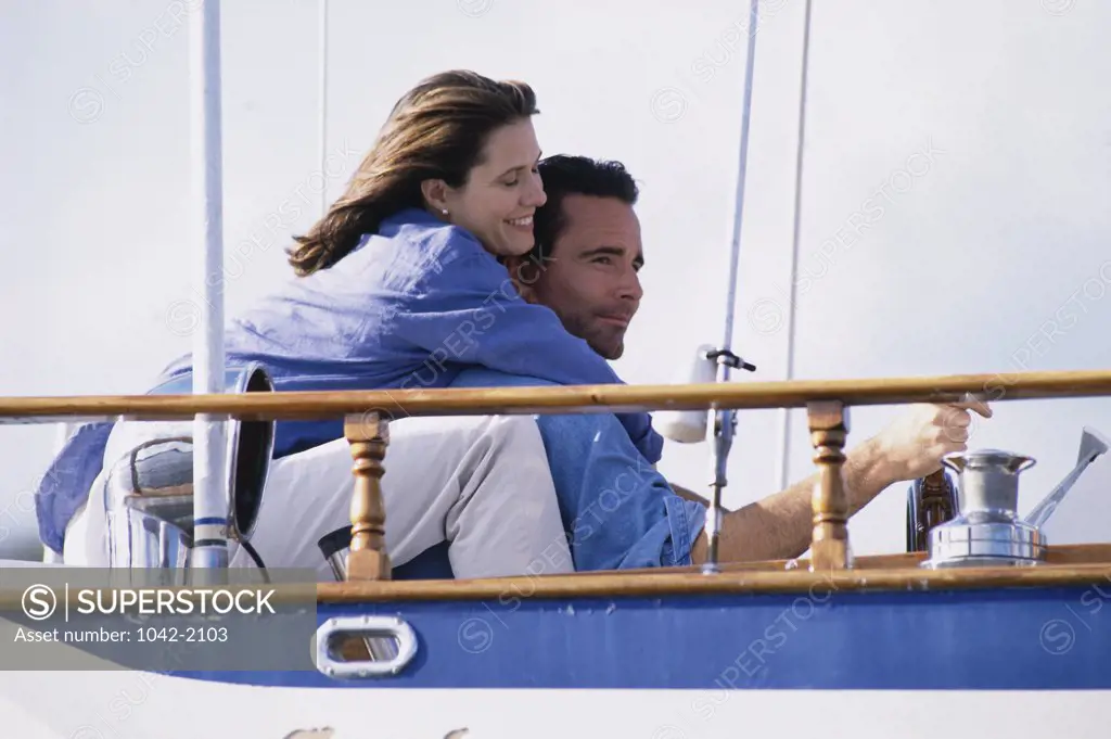 Side profile of a young couple together on a sailboat