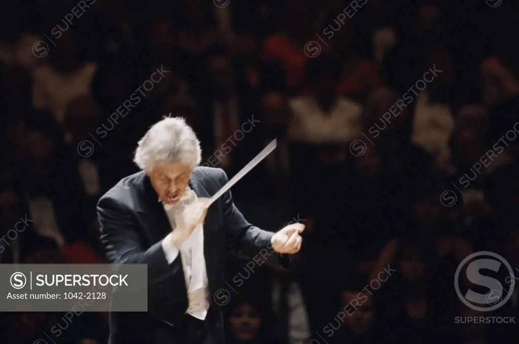 High angle view of a conductor leading a symphony orchestra