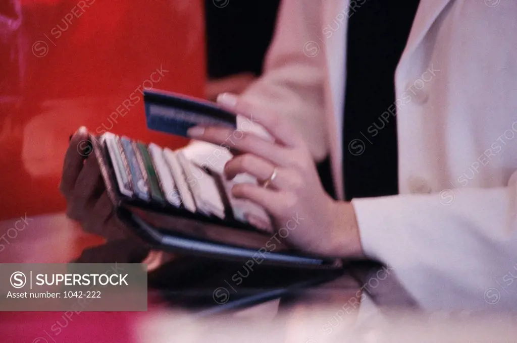 Mid section view of a woman holding a credit card
