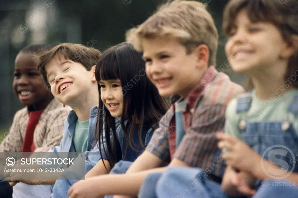 Side profile of a group of children sitting side by side